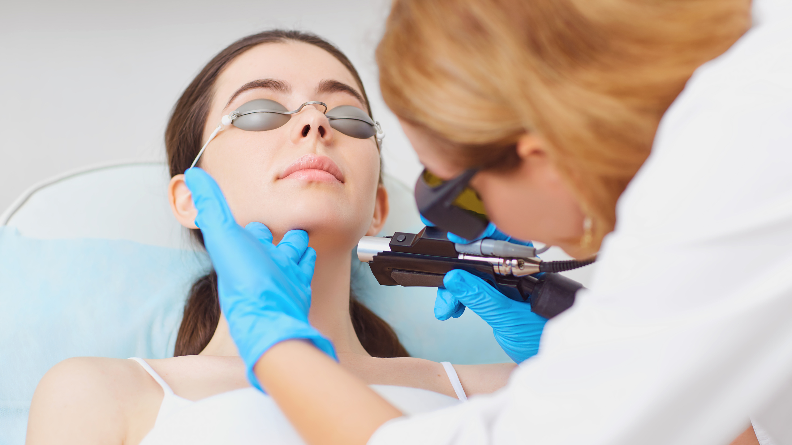 woman getting laser hair removal on chin